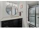 Bathroom featuring a modern vanity with marble countertop, updated light fixture, and glass enclosed shower at 14252 E Radcliff Cir, Aurora, CO 80015