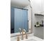 Bathroom mirror showing the shower with blue shower curtain, towels, and decorative shelving at 14252 E Radcliff Cir, Aurora, CO 80015