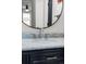 Bathroom vanity featuring a marble countertop, modern faucet, and dark cabinetry at 14252 E Radcliff Cir, Aurora, CO 80015