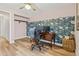 Charming bedroom featuring a workspace and appealing floral wallpaper accents at 14252 E Radcliff Cir, Aurora, CO 80015