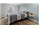 Bedroom with wood floors, a window, and a bed with grey, white, and pink linens at 14252 E Radcliff Cir, Aurora, CO 80015