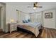 Bright bedroom featuring hardwood floors, ample natural light, and cozy furnishings at 14252 E Radcliff Cir, Aurora, CO 80015