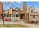 Charming townhome with a picket fence and a brick chimney, offering cozy curb appeal at 14252 E Radcliff Cir, Aurora, CO 80015
