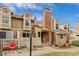 A charming home with a brick chimney, fenced yard with garden and view of blue sky at 14252 E Radcliff Cir, Aurora, CO 80015