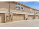 Attached garages for townhome community with visible address markers at 14252 E Radcliff Cir, Aurora, CO 80015