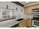 Granite countertops and stainless steel appliances overlooking the dining area at 14252 E Radcliff Cir, Aurora, CO 80015