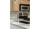 Close-up of the kitchen sink, granite countertop, and stainless steel appliances at 14252 E Radcliff Cir, Aurora, CO 80015