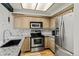 Updated kitchen featuring stainless steel appliances, granite countertops, and ample cabinet space at 14252 E Radcliff Cir, Aurora, CO 80015