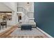 Bright living room features modern staircase, blue accent wall, and open-concept layout with stylish furniture at 14252 E Radcliff Cir, Aurora, CO 80015