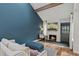 Cozy living room features a brick fireplace, vaulted ceiling, and stylish decor, perfect for relaxation at 14252 E Radcliff Cir, Aurora, CO 80015