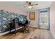 Office space features a desk, rolling chair, a floral accent wall, and a ceiling fan at 14252 E Radcliff Cir, Aurora, CO 80015