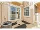 Small tan patio area with sliding glass door, window, and HVAC at 14252 E Radcliff Cir, Aurora, CO 80015