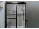 Updated tile shower with glass door, built in bench, and built-in storage at 14252 E Radcliff Cir, Aurora, CO 80015