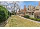 Exterior view of townhomes featuring well-maintained landscaping and walkways at 14252 E Radcliff Cir, Aurora, CO 80015