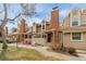 Exterior of townhomes with brick chimneys and outdoor patio spaces at 14252 E Radcliff Cir, Aurora, CO 80015