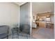 Balcony view into an open-concept dining room and kitchen at 909 N Logan St # 10C, Denver, CO 80203