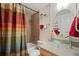 Bathroom features glass bowl sink, decorative mirror, tiled shower and colorful shower curtain at 909 N Logan St # 10C, Denver, CO 80203
