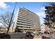 Full building view featuring multiple floors, balconies, and surrounding street with parked cars at 909 N Logan St # 10C, Denver, CO 80203