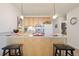A full kitchen with breakfast bar provides an eating space and a place to prepare food at 909 N Logan St # 10C, Denver, CO 80203