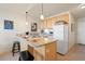 Open kitchen features a breakfast bar with seating and abundant cabinet space at 909 N Logan St # 10C, Denver, CO 80203