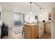Kitchenette featuring tile flooring, a view to an outside balcony, white appliances and pendant lights at 909 N Logan St # 10C, Denver, CO 80203