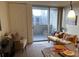 Cozy living room with a large sliding glass door that leads to a city view balcony at 909 N Logan St # 10C, Denver, CO 80203