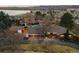 Property aerial view, showing a lake view and multiple buildings on an oversized lot at 7382 W Stanford Ave, Littleton, CO 80123