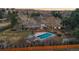 Aerial view of the home showing the sunroom, pool, and pool house situated on a large lot at 7382 W Stanford Ave, Littleton, CO 80123