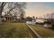 Backyard view showcasing the pool, pool house, and mature trees at dusk at 7382 W Stanford Ave, Littleton, CO 80123