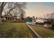 Backyard view showcasing the pool, pool house, and mature trees at twilight at 7382 W Stanford Ave, Littleton, CO 80123