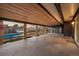 Expansive covered patio features wood ceilings and overlooks a swimming pool and backyard at 7382 W Stanford Ave, Littleton, CO 80123