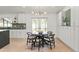 Cozy dining area with modern light fixture, view of kitchen and french doors to backyard at 7382 W Stanford Ave, Littleton, CO 80123