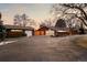Charming brick home featuring a three-car garage and expansive driveway, beautifully maintained yard at 7382 W Stanford Ave, Littleton, CO 80123