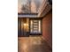 Close up of the front door with sidelights and house number on a well lit porch at 7382 W Stanford Ave, Littleton, CO 80123