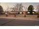 Inviting home exterior showcasing a well-kept yard, fence, and long driveway at 7382 W Stanford Ave, Littleton, CO 80123