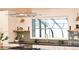 Bright kitchen with a large garden window, stainless steel appliances, and stylish decor at 7382 W Stanford Ave, Littleton, CO 80123