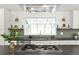 Modern kitchen with white cabinets, a large window above the sink, and stainless steel appliances at 7382 W Stanford Ave, Littleton, CO 80123