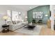 Bright living room with a large window, comfortable seating, and a stylish accent wall at 7382 W Stanford Ave, Littleton, CO 80123