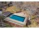 Aerial view of the in-ground pool with diving board and surrounding patio and fenced yard at 7382 W Stanford Ave, Littleton, CO 80123