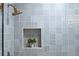 Close-up of the shower highlighting the blue tile and shower fixtures at 7382 W Stanford Ave, Littleton, CO 80123