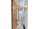 Bright bathroom featuring white tile, a new vanity, and modern fixtures at 1658 Winona Ct, Denver, CO 80204