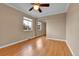 Inviting bedroom with hardwood floors, window, and mirrored closet at 1658 Winona Ct, Denver, CO 80204