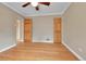 Bedroom featuring hardwood floors, fresh paint, and two closets at 1658 Winona Ct, Denver, CO 80204