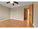 Spacious bedroom with hardwood floors and a wooden door to the hallway at 1658 Winona Ct, Denver, CO 80204
