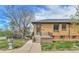Charming brick home featuring a small front porch, well-maintained lawn, and inviting curb appeal at 1658 Winona Ct, Denver, CO 80204