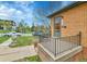 Close-up of the charming brick home's front porch with wrought iron railing and inviting entry at 1658 Winona Ct, Denver, CO 80204