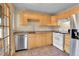 Sunlit kitchen boasts stainless steel appliances and warm wood cabinetry at 1658 Winona Ct, Denver, CO 80204