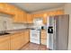 Well-lit kitchen with stainless steel refrigerator and gas range at 1658 Winona Ct, Denver, CO 80204
