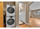 Convenient laundry area with stacked washer and dryer, adjacent to a tidy bathroom at 1658 Winona Ct, Denver, CO 80204
