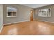 Bright living room featuring hardwood floors, neutral walls, and updated windows for plenty of natural light at 1658 Winona Ct, Denver, CO 80204
